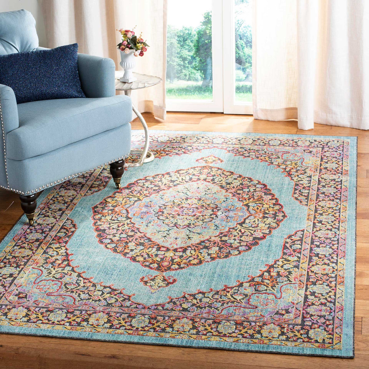 Aqua medallion rug brings intricate floral color to a bright living room