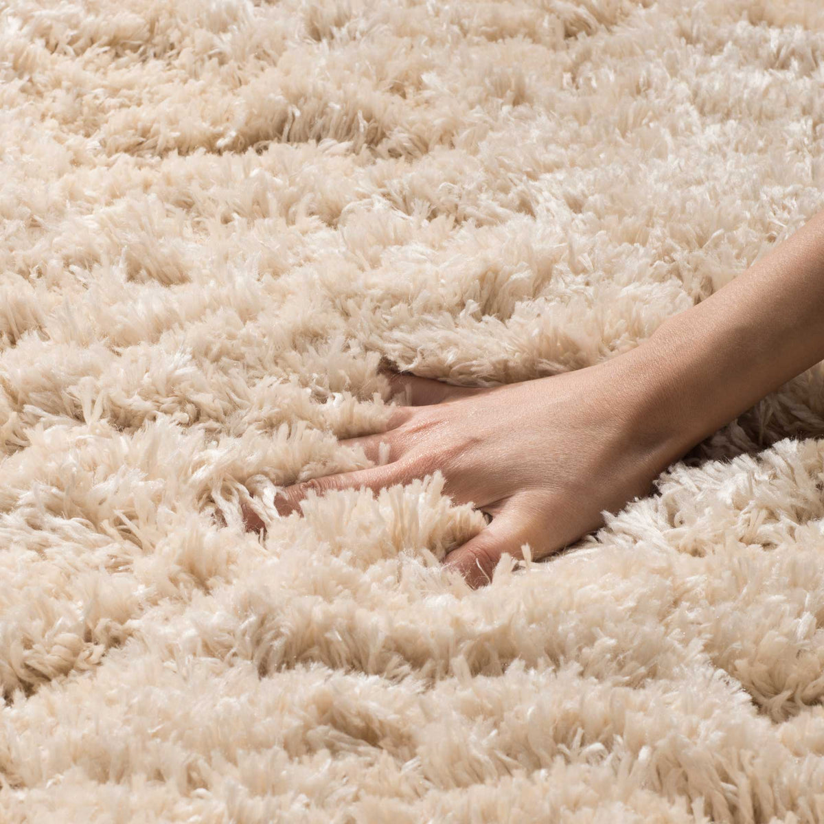 Deep light beige shag fibers yield softly to the touch for a luxurious, sink-in feel.