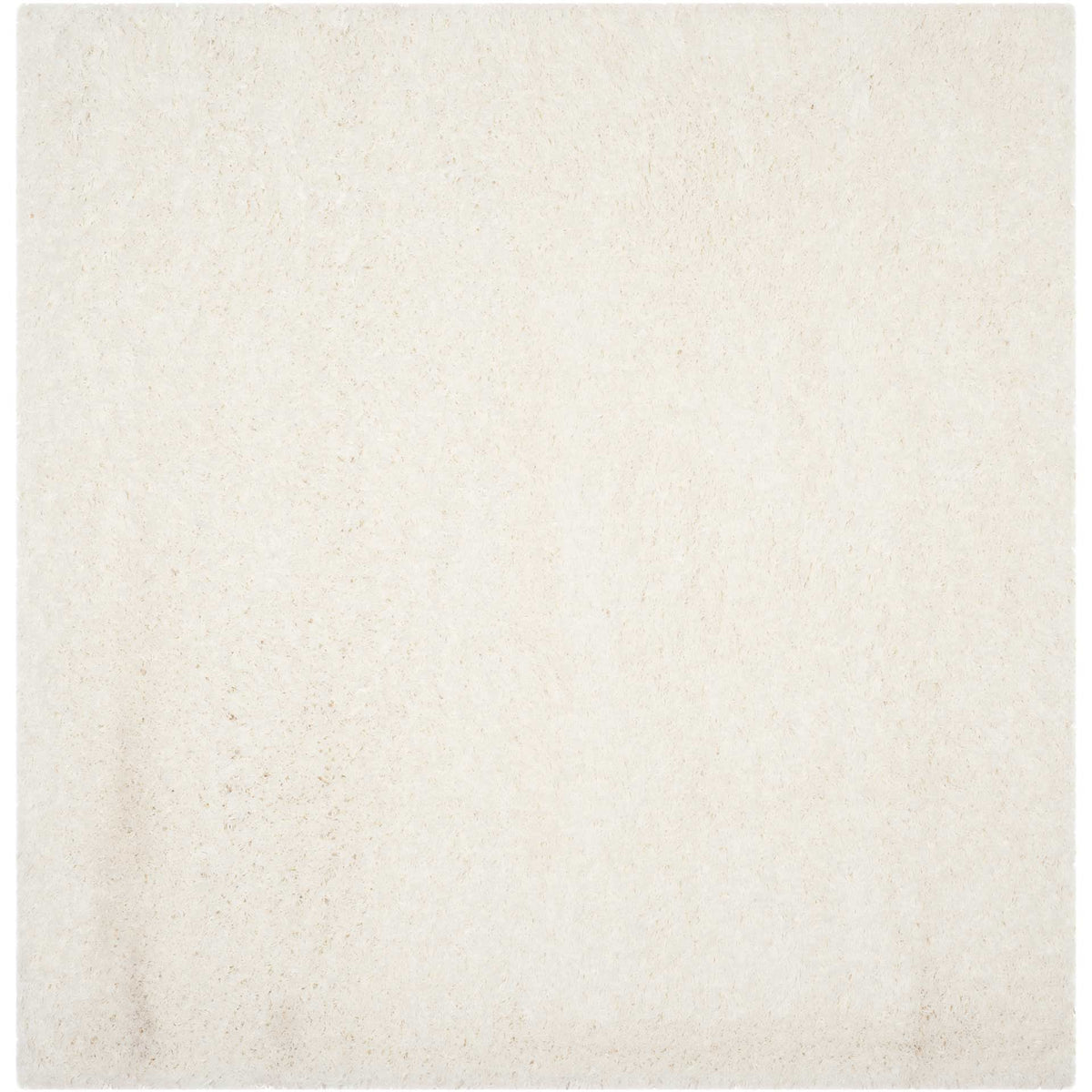 A square white shag rug creates a cloudlike layer of texture in a crisp neutral shade.