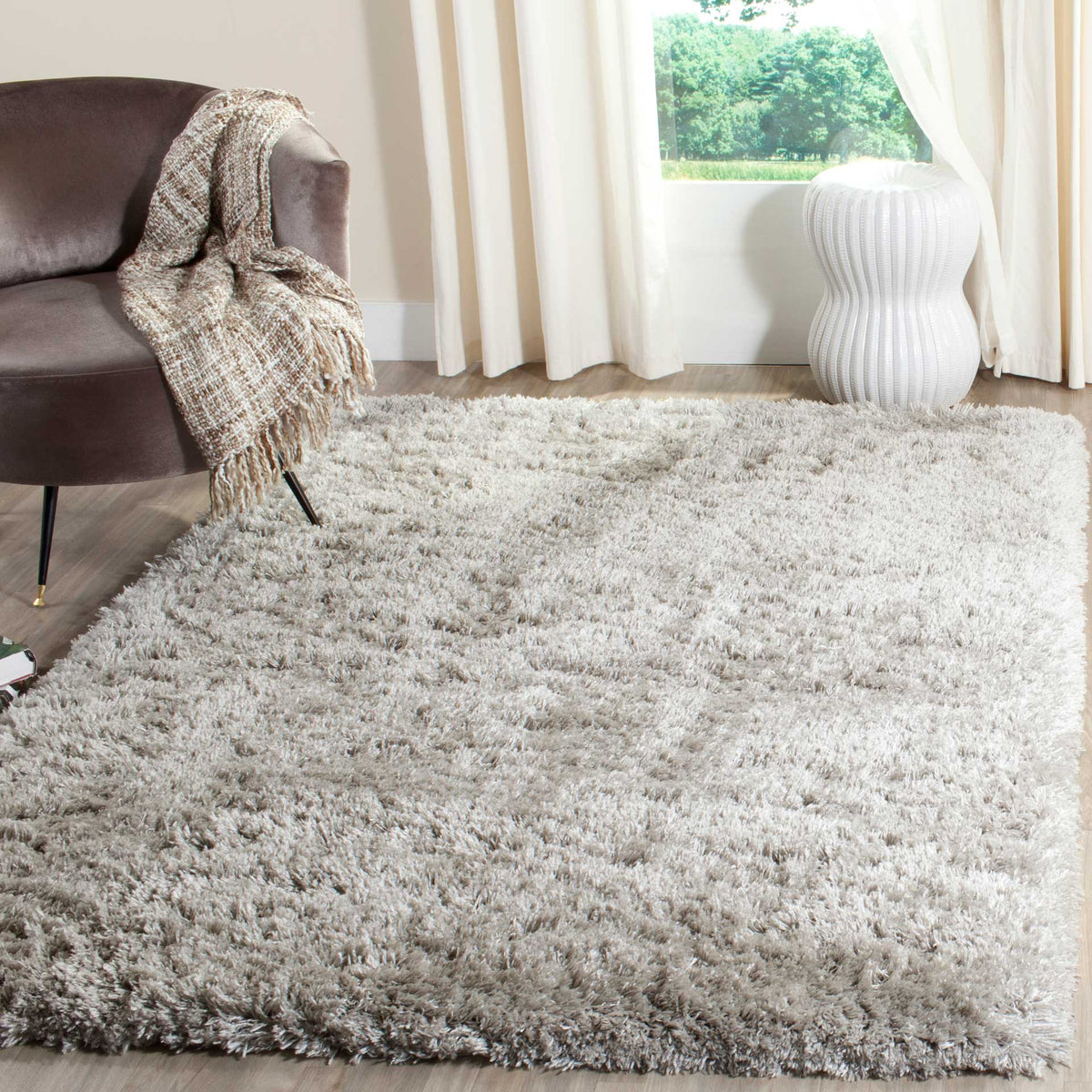 A silver shag rug brings airy gray color and a plush foundation to a relaxing space.