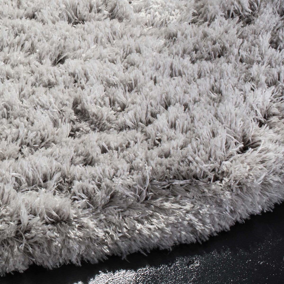 Thick silver-gray shag fibers create a plush, softly shaded edge