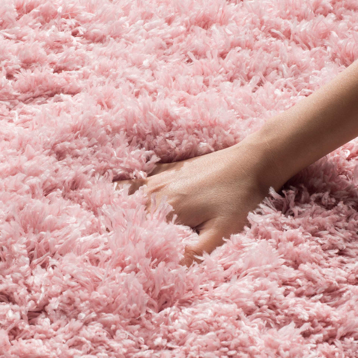 Light pink shag fibers cushion the touch with a lofty, irresistibly soft pile.