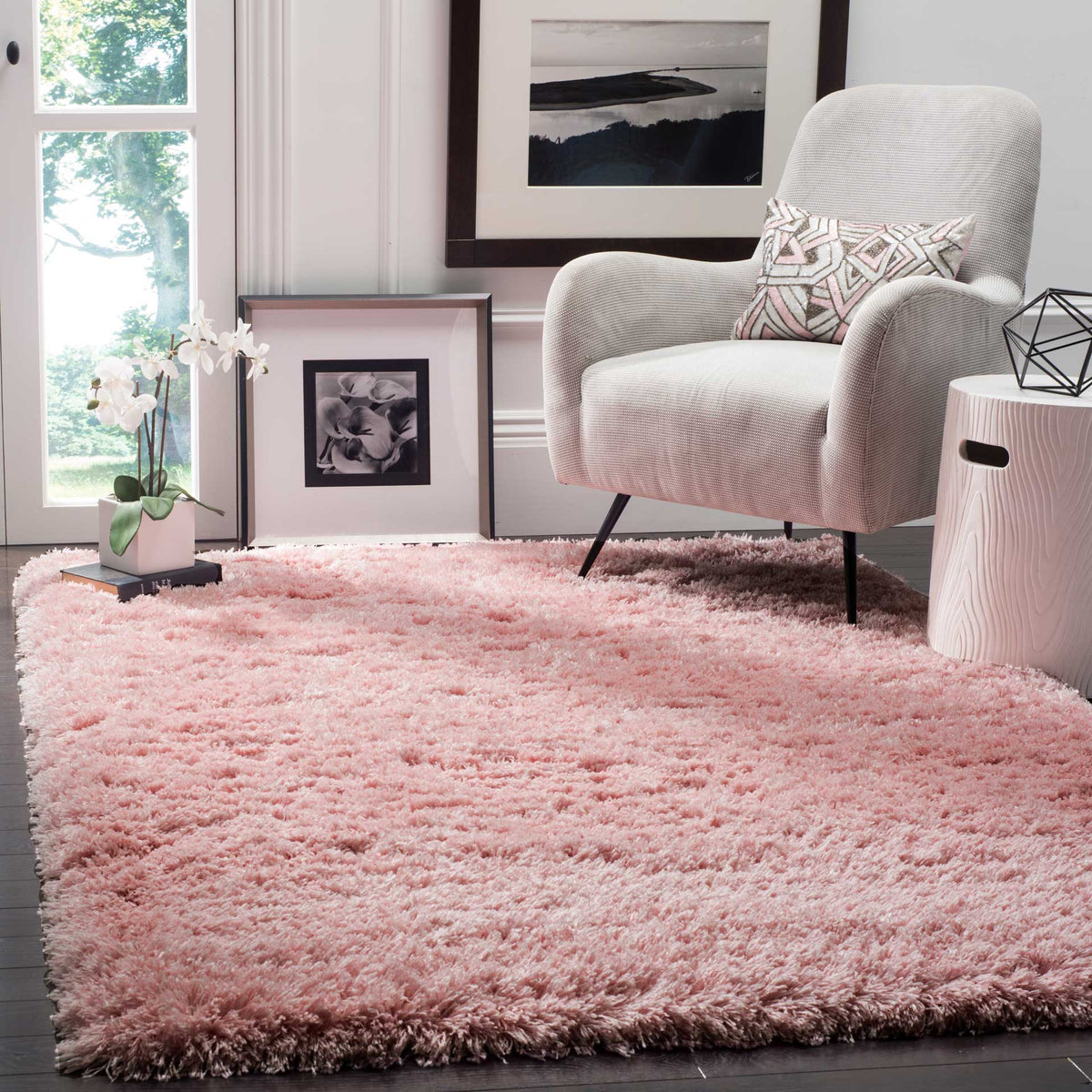 A light pink shag rug brings gentle color and plush comfort beneath a lounge chair.