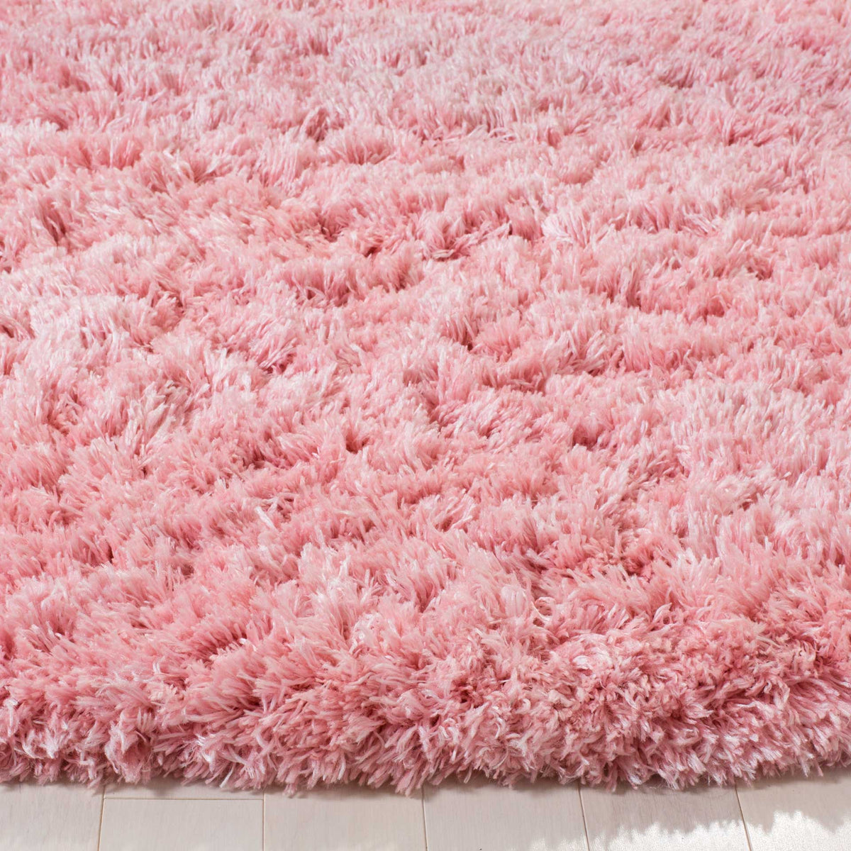 Soft pink shag fibers form a thick, feathery edge with cozy texture