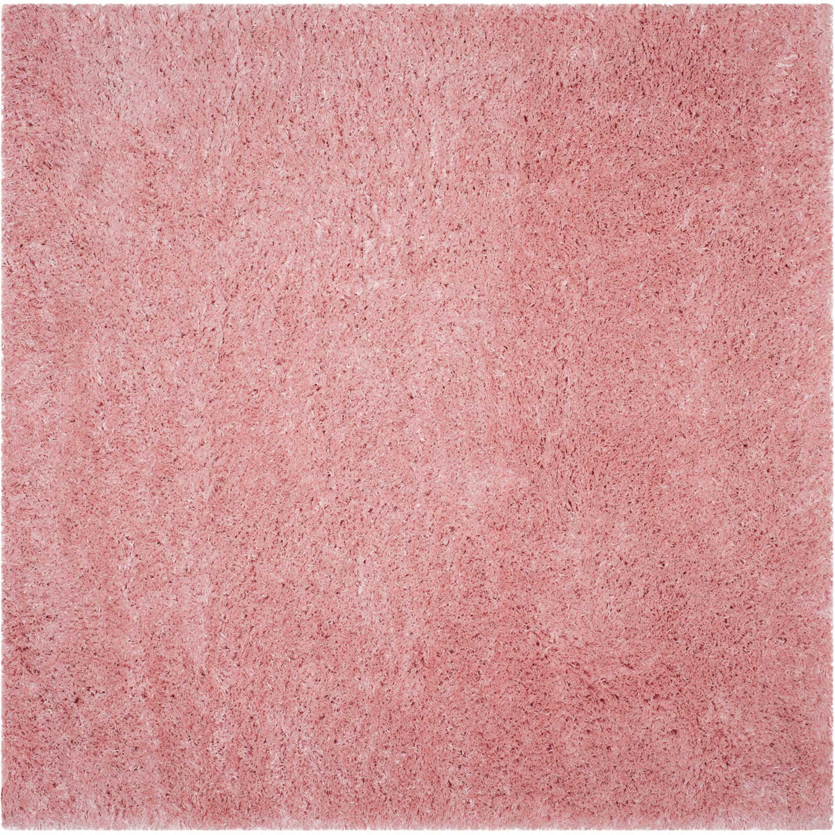 A square light pink shag rug offers cloudlike texture across its plush surface.