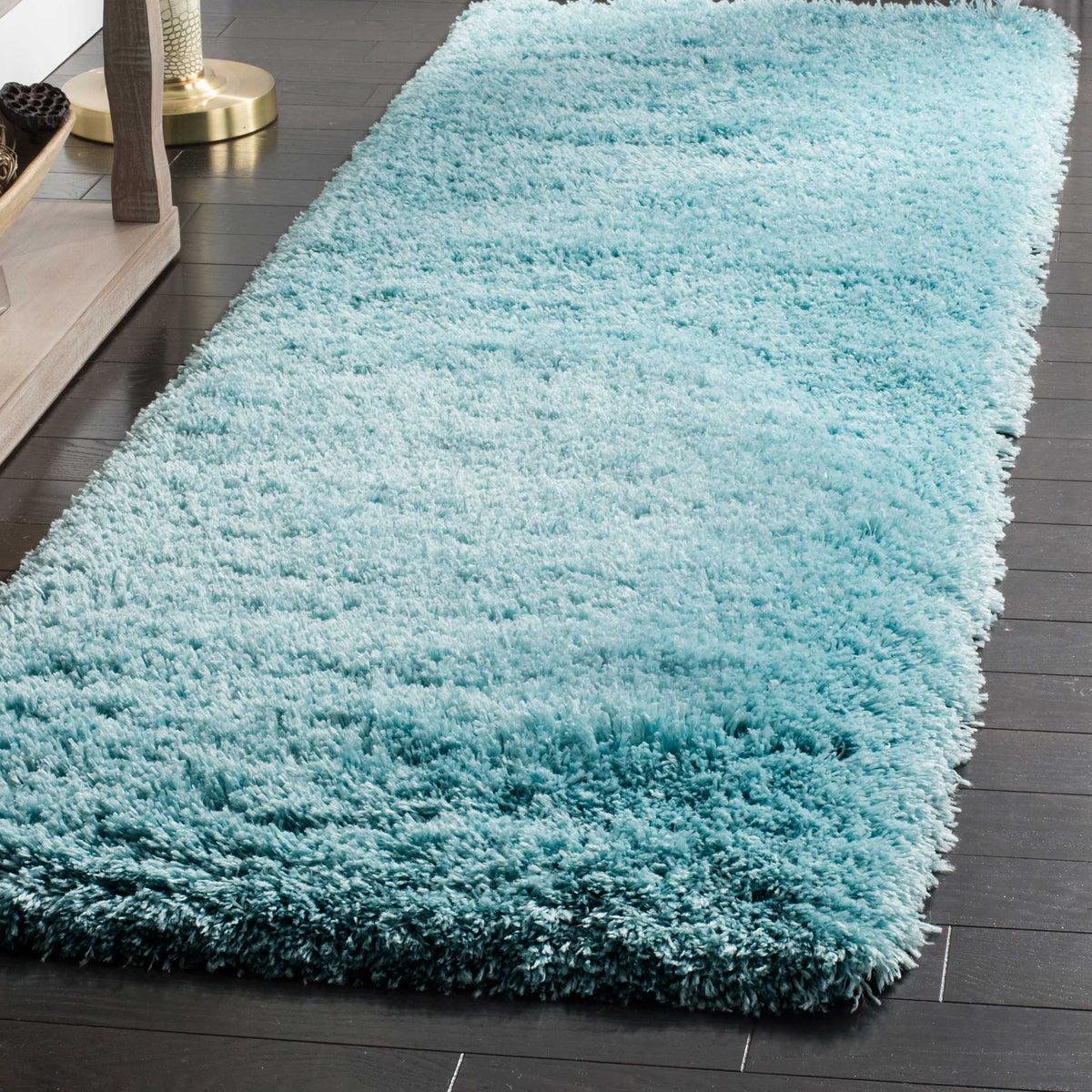Deep, fluffy turquoise pile brings fresh color and soft texture to the floor