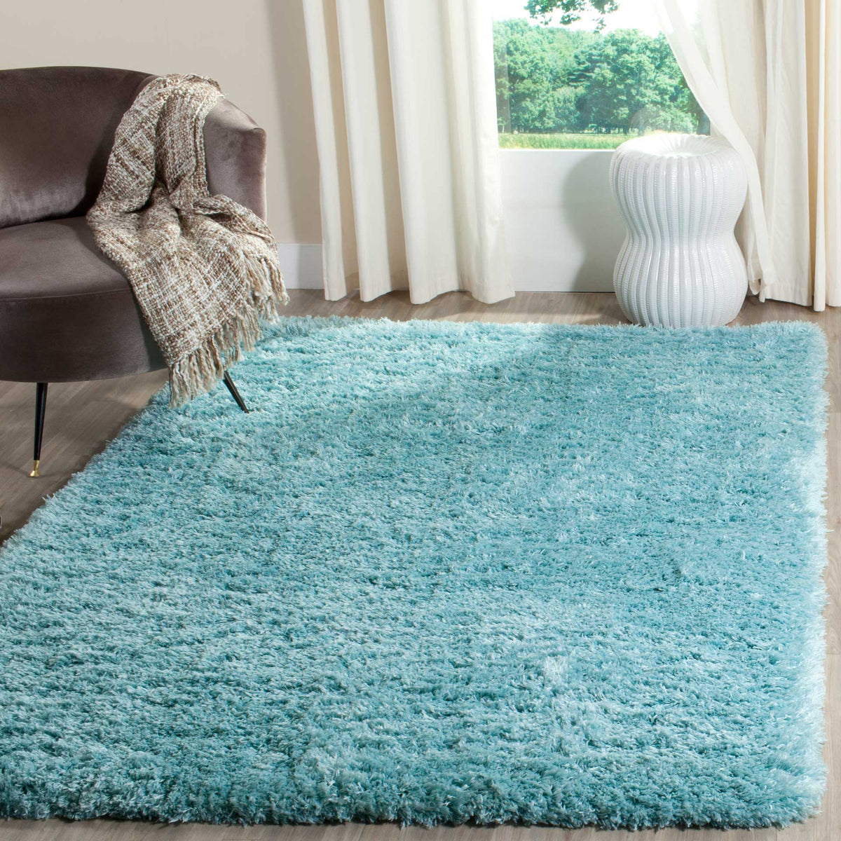 A light turquoise shag rug adds blue-green color and cozy texture to a seating area.