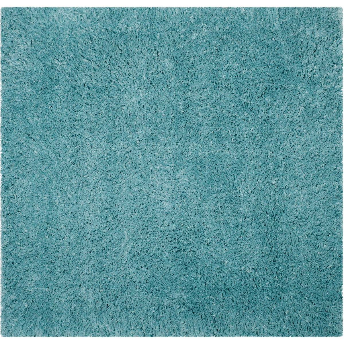 A square light turquoise shag rug adds blue-green color and inviting softness.