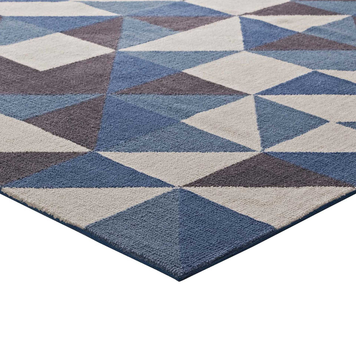 Blue edge binding frames soft, interlocking triangles in blue, gray, and white
