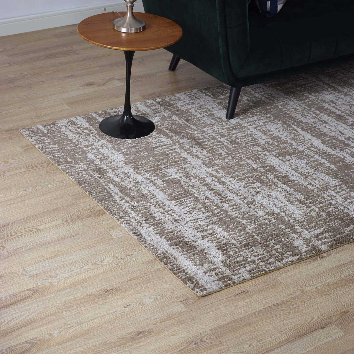 Light and dark tan tones add warmth and soft texture beneath a sofa and side table.