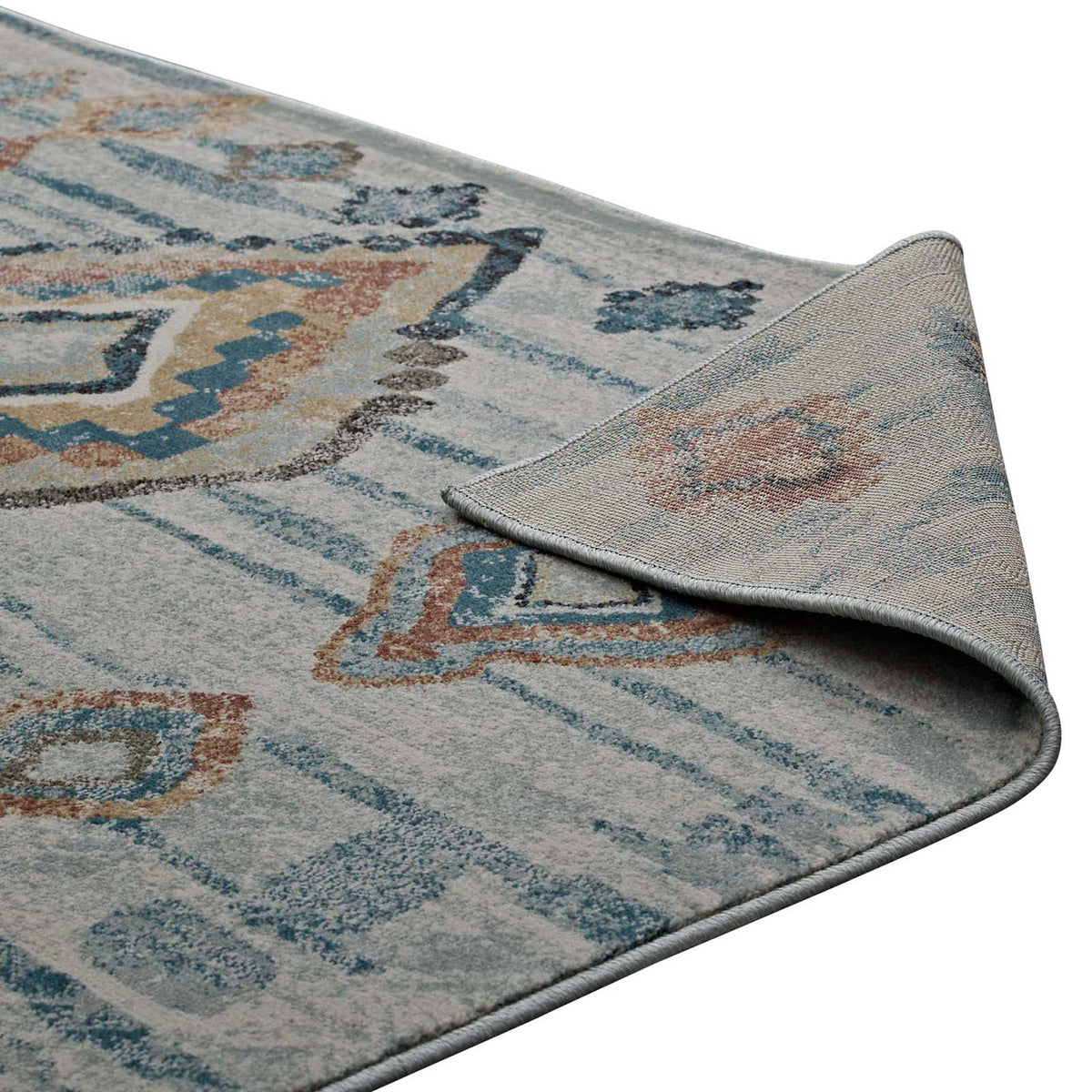 A flexible woven underside and bound edges complement the rug's geometric design