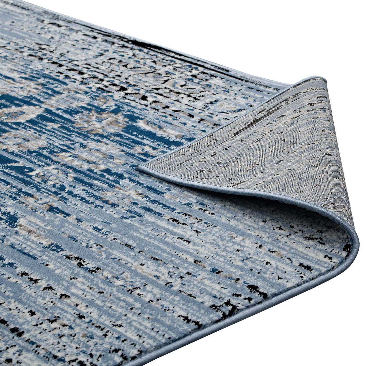 A textured backing and finished edge complement the rug's layered blue floral design.