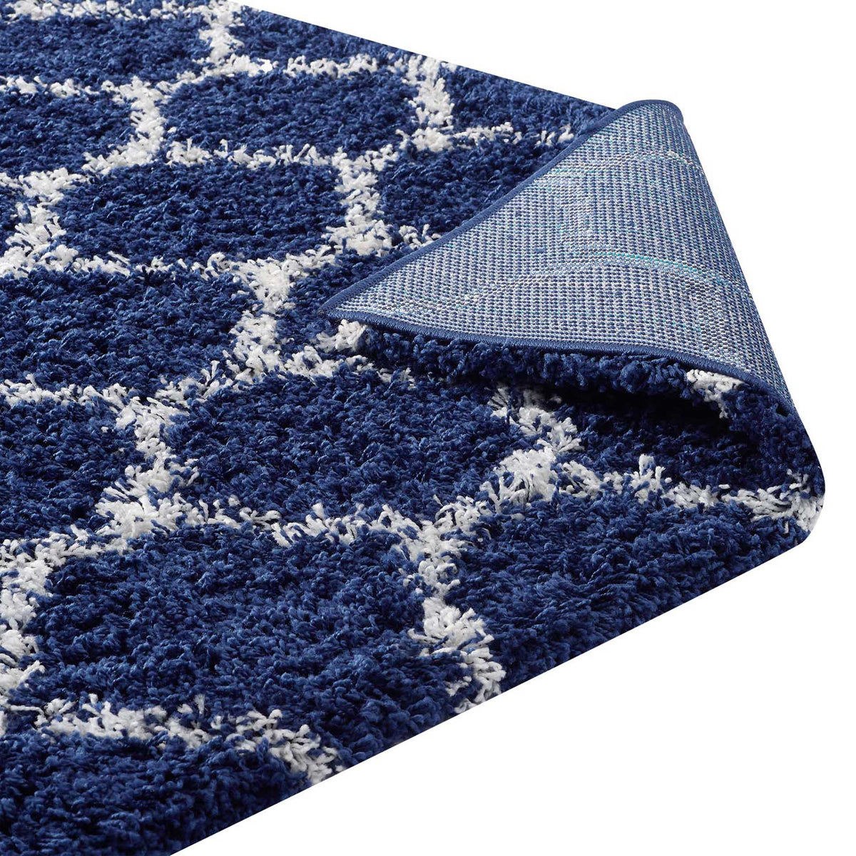 Woven backing and a bound edge give the navy and ivory shag rug a neat finish