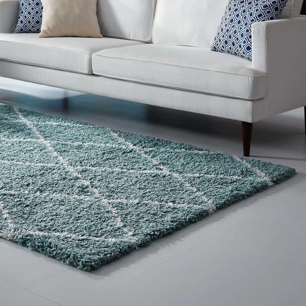 Thick aqua blue shag and ivory lattice lines give the rug a cozy, softly finished edge.