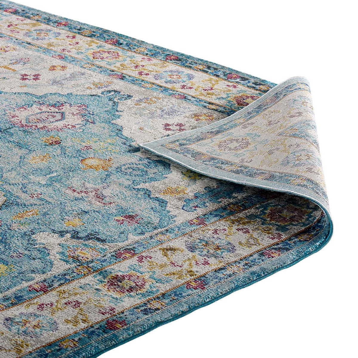 The floral rug's folded edge reveals a tightly woven, flexible underside