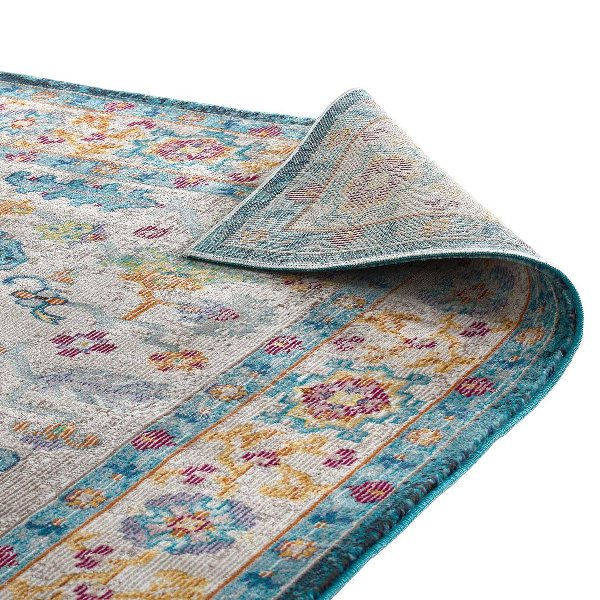 The flexible blue floral rug has a tightly woven underside and a finished edge