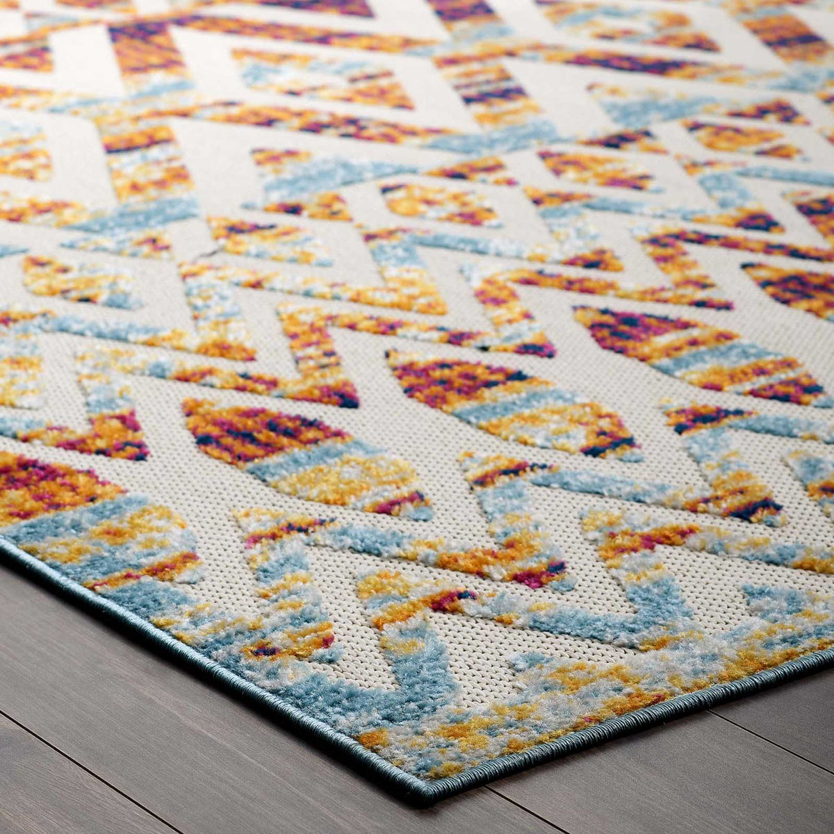 Soft blue binding outlines vivid zigzags and warm-toned diamond motifs