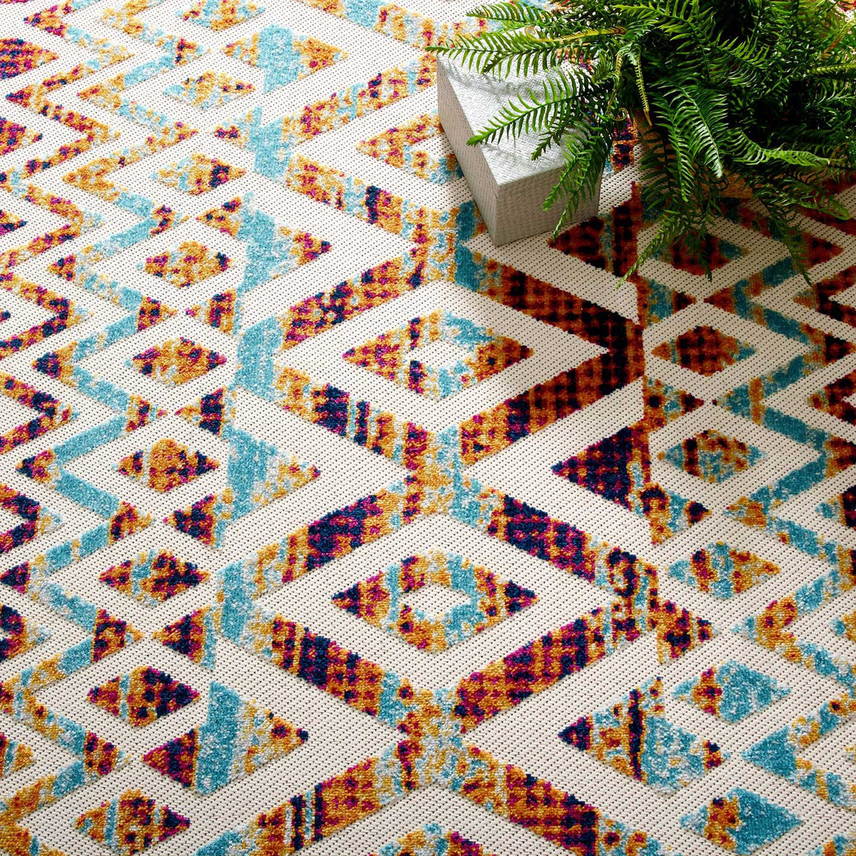 Oversized diamonds and intricate blue and orange accents make a vivid graphic statement