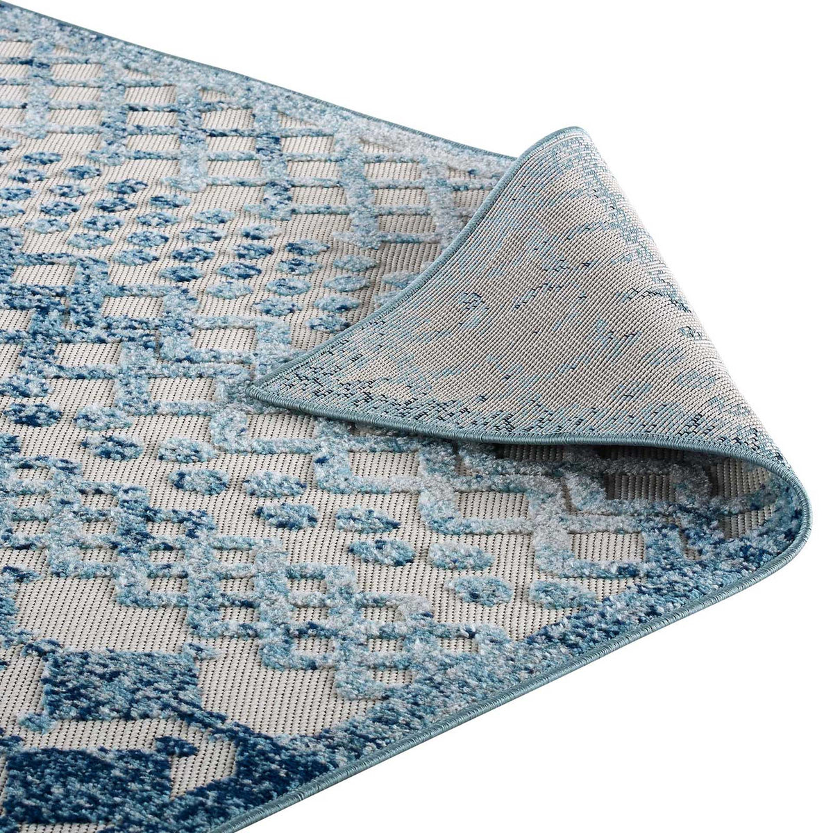 Woven backing and bound trim complement this flexible ivory and blue patterned rug