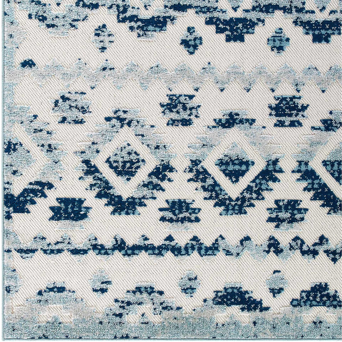 Faded blue diamond rows and small geometric marks create a rich pattern on ivory