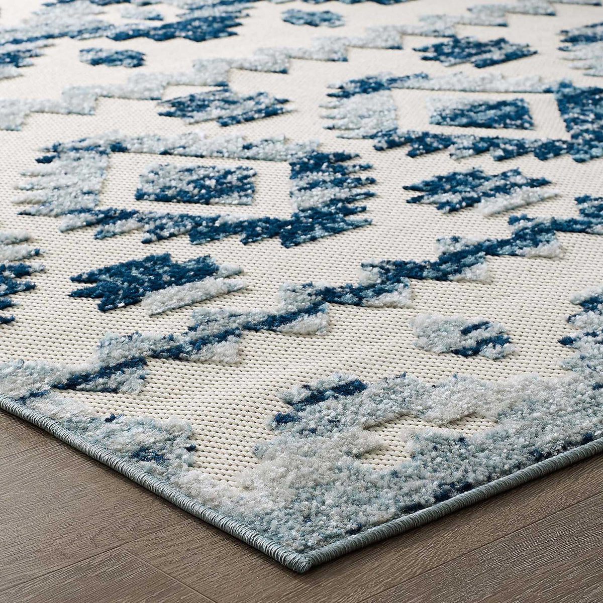 Raised blue details stand out against the tight ivory weave and tailored edging