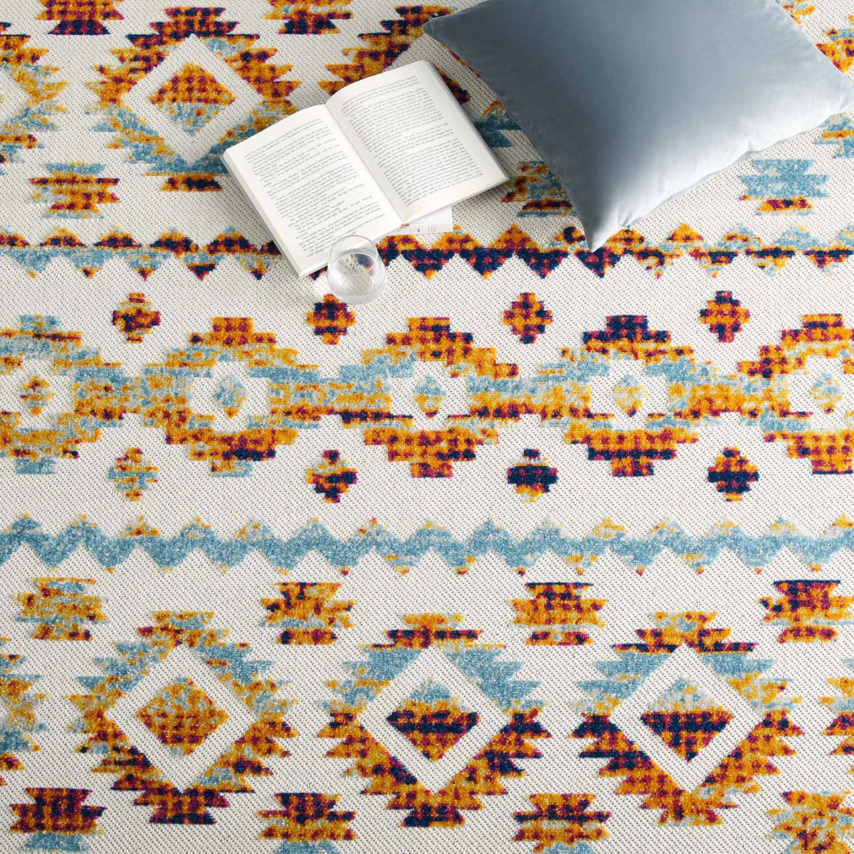 Blue zigzags and warm-toned diamonds energize the rug beneath casual lounge accents
