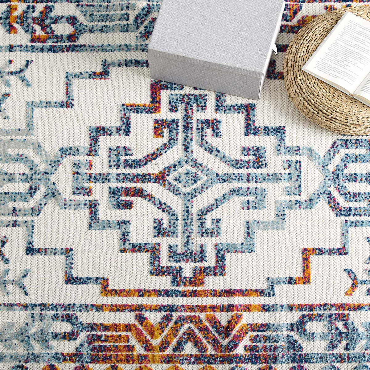 A stepped blue medallion and warm geometric border balance color with symmetry
