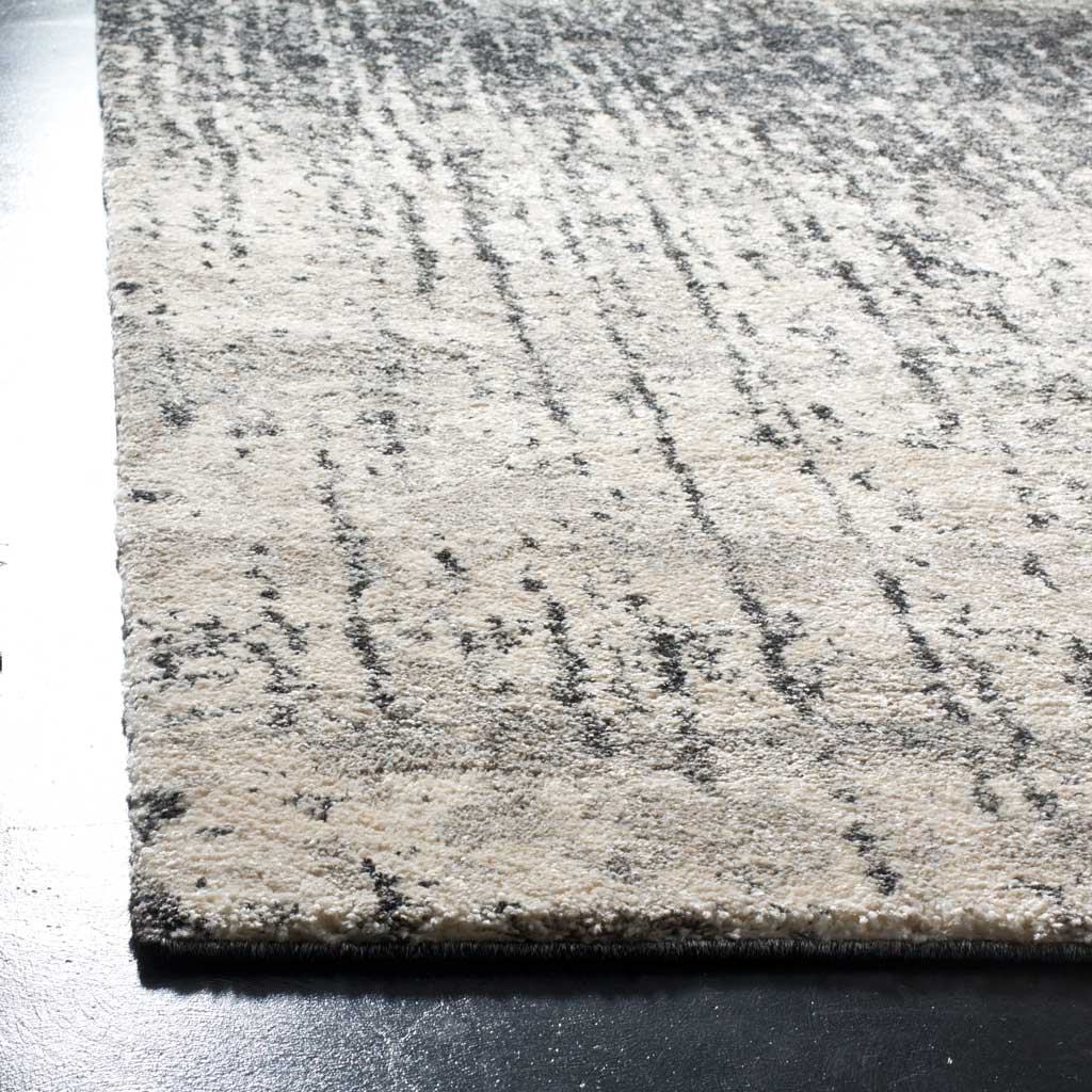 Neatly finished corner shows textured light gray pile with fine black streaks