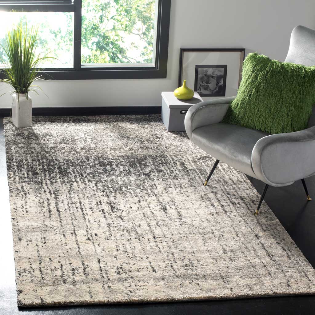 Black and light gray rug brings a softly weathered abstract pattern to a modern seating area