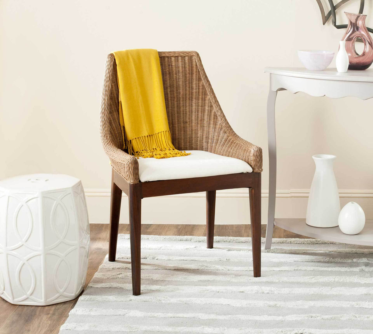 Brown rattan weave and a white cushioned seat bring natural texture to a bright interior