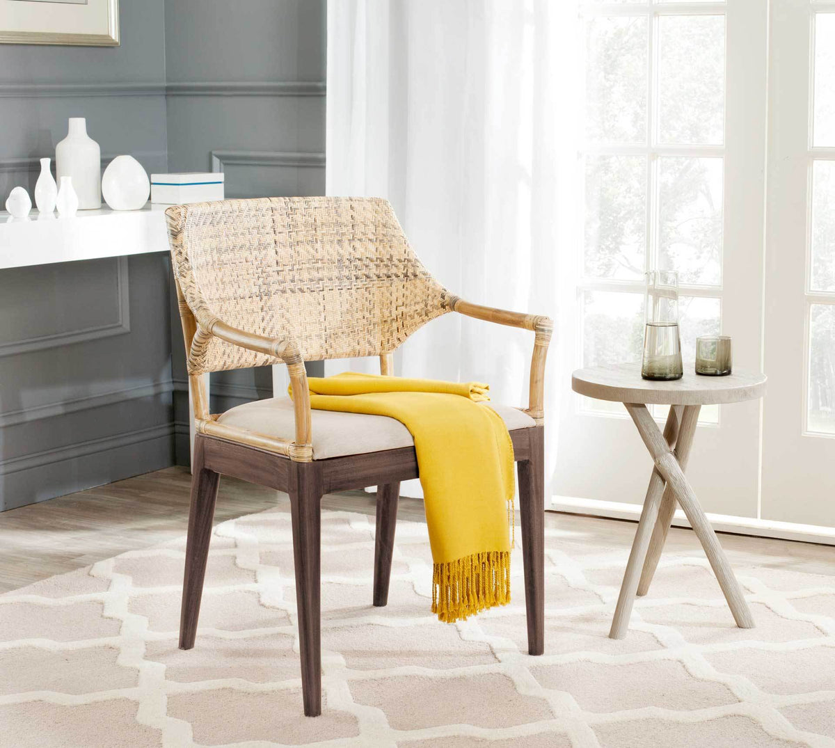 A natural woven back and soft beige seat give this dark wood armchair a relaxed, inviting feel.