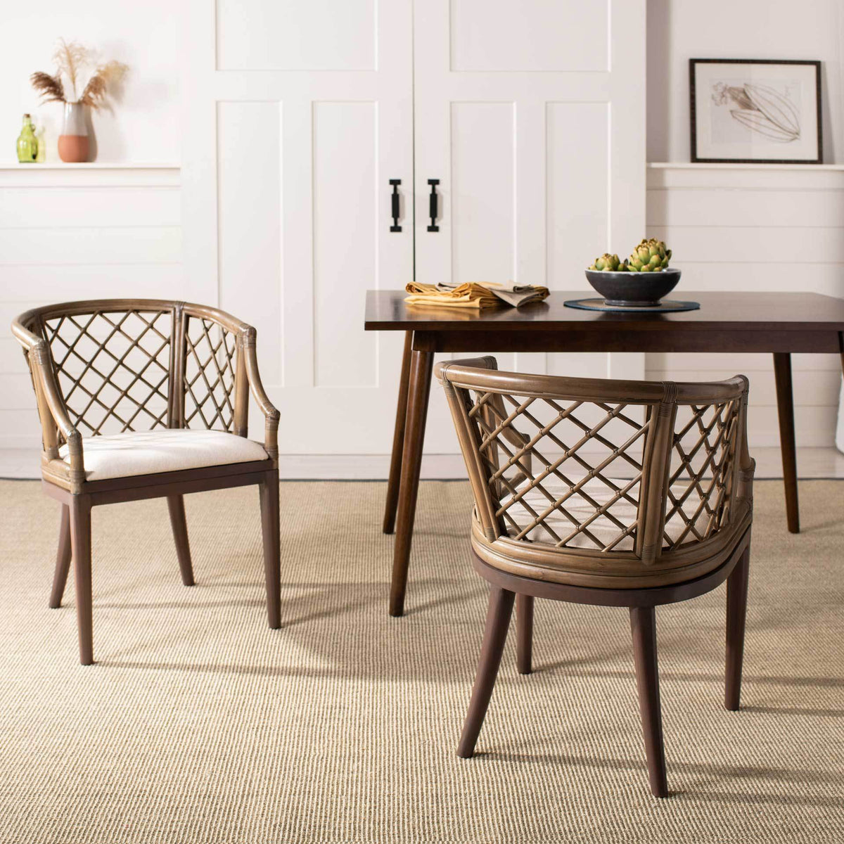 Lattice-back chairs with white cushions add airy texture and coastal warmth beside a dining table.