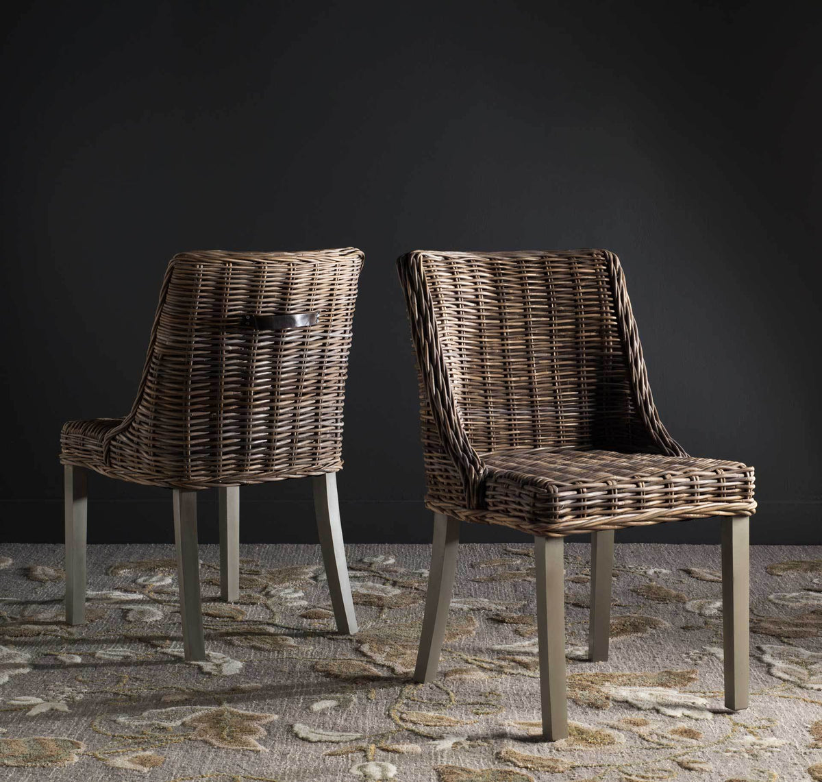 Two gray wicker chairs bring organic texture and airy silhouettes to a richly layered room.