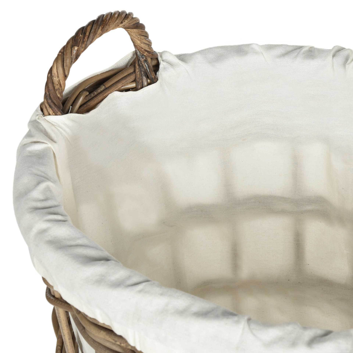 A soft white cotton liner folds over the woven rim beside a sturdy twisted rattan handle