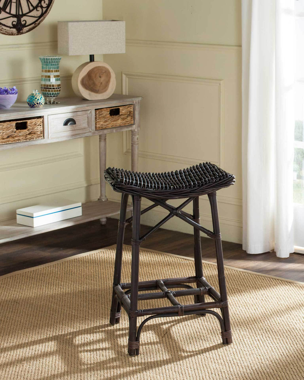 Woven dark brown rattan and a sculpted seat bring natural texture to this bar stool