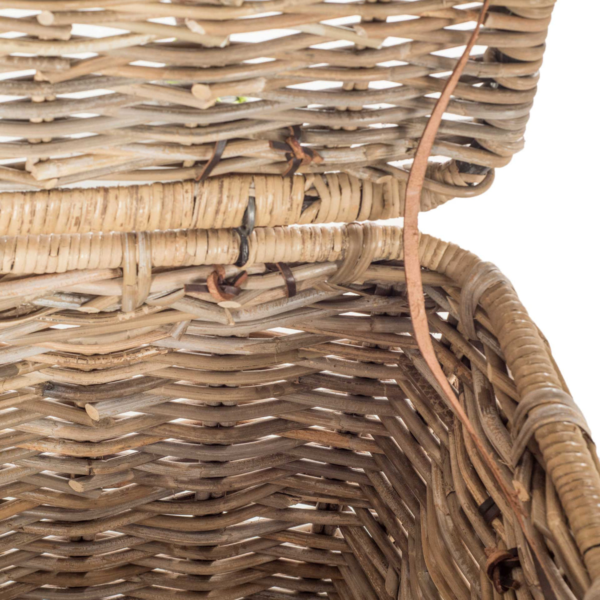 Natural rattan weave lines the trunk's interior and lid, with wrapped edges along the rim
