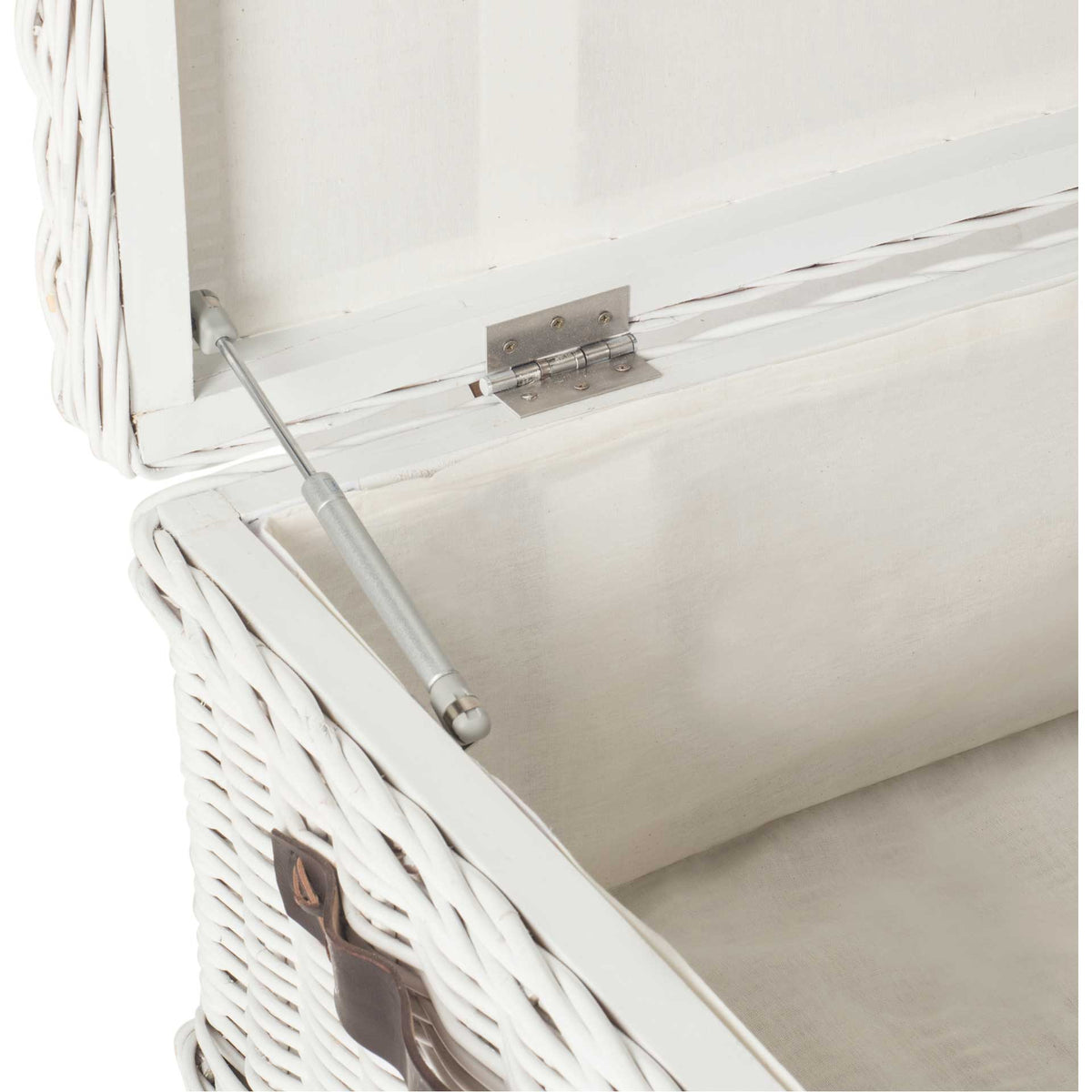 A metal lid support and hinge sit inside the white, fabric-lined rattan trunk