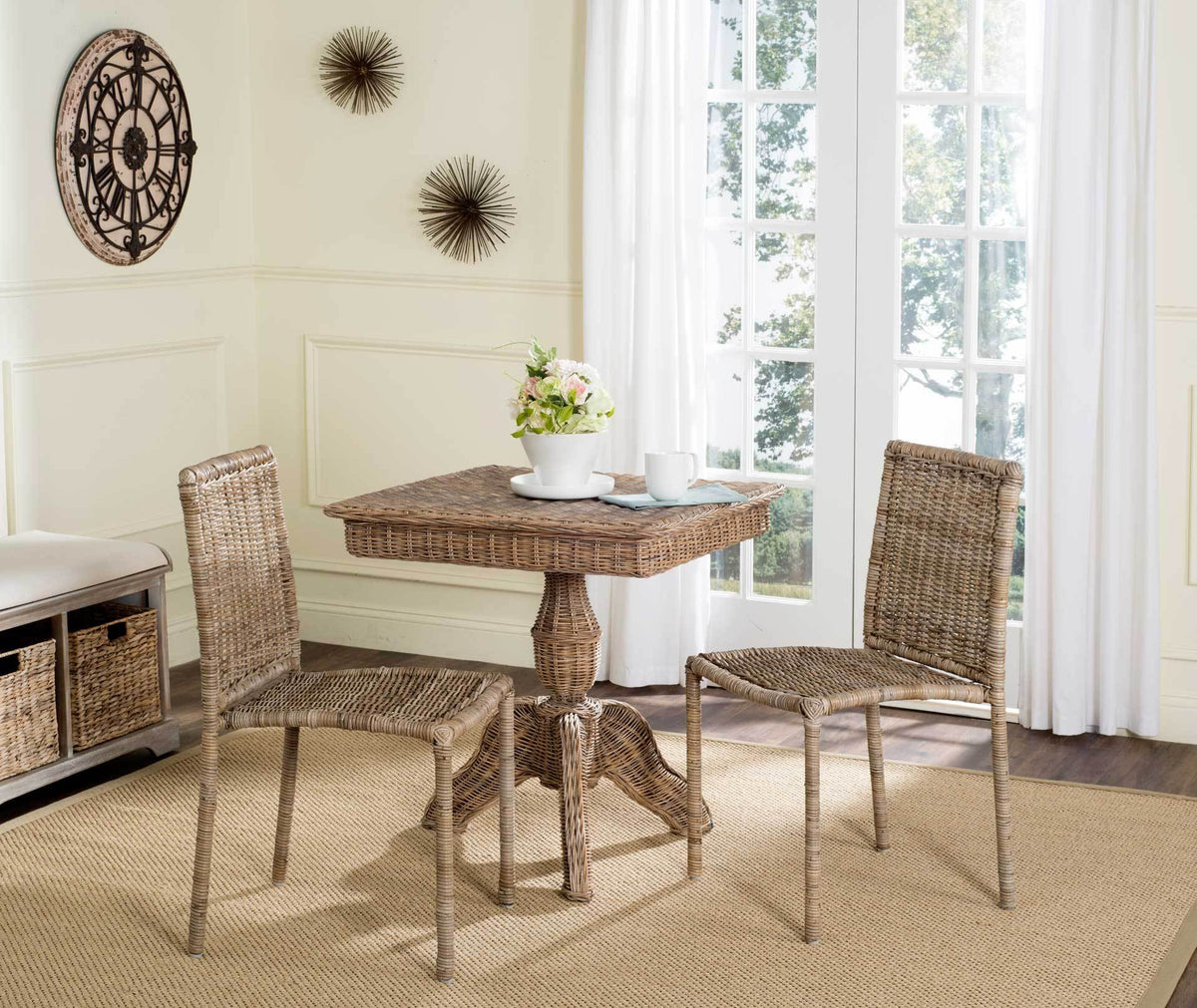 A pair of woven rattan side chairs brings natural texture to a bright dining nook