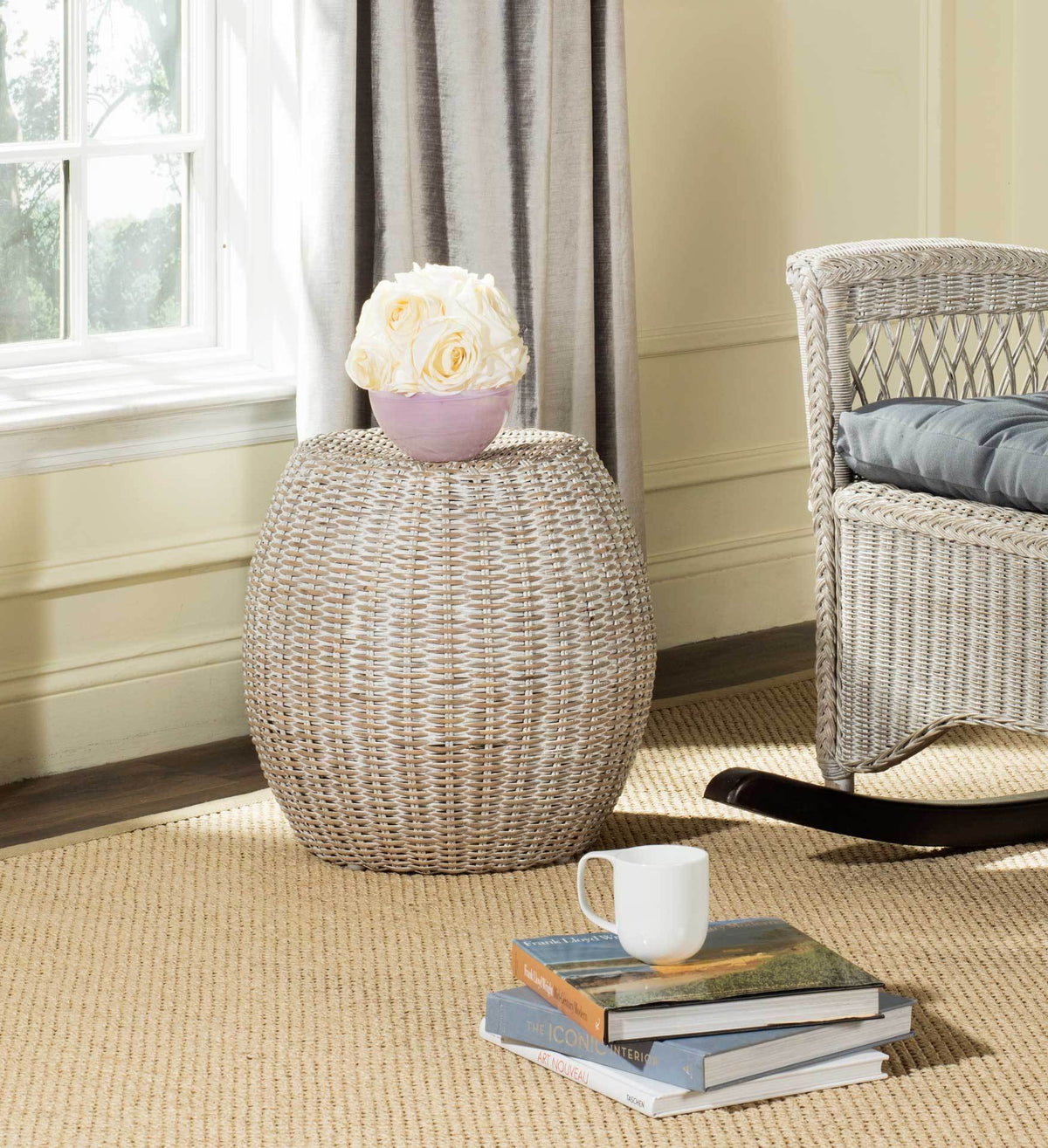 Light woven rattan end table with a rounded profile and space for a vase of flowers