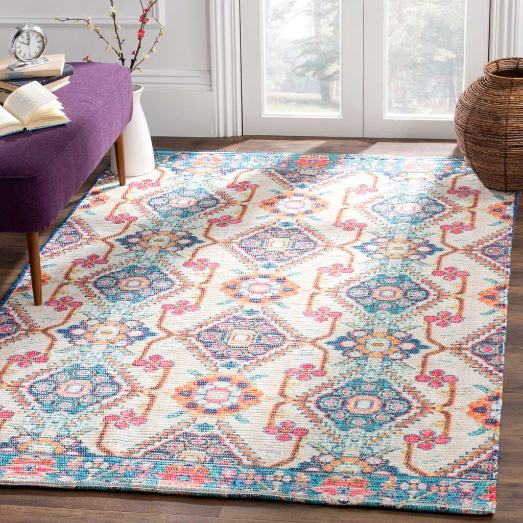 A cream rug with blue and coral motifs adds lively color beside purple seating and warm wood floors
