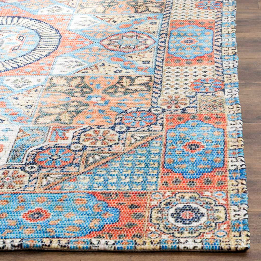 Intricate floral and geometric motifs frame the rug's vivid blue and orange edge