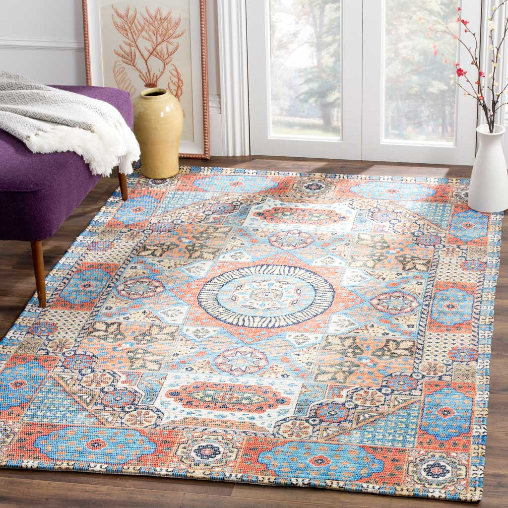 Bright orange and blue medallion rug adds lively pattern beneath cozy seating
