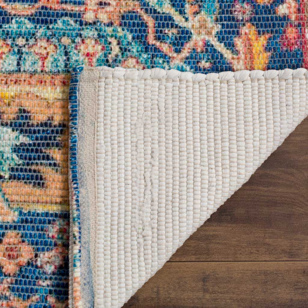 A cream woven backing contrasts with the rug's vivid blue and orange pattern