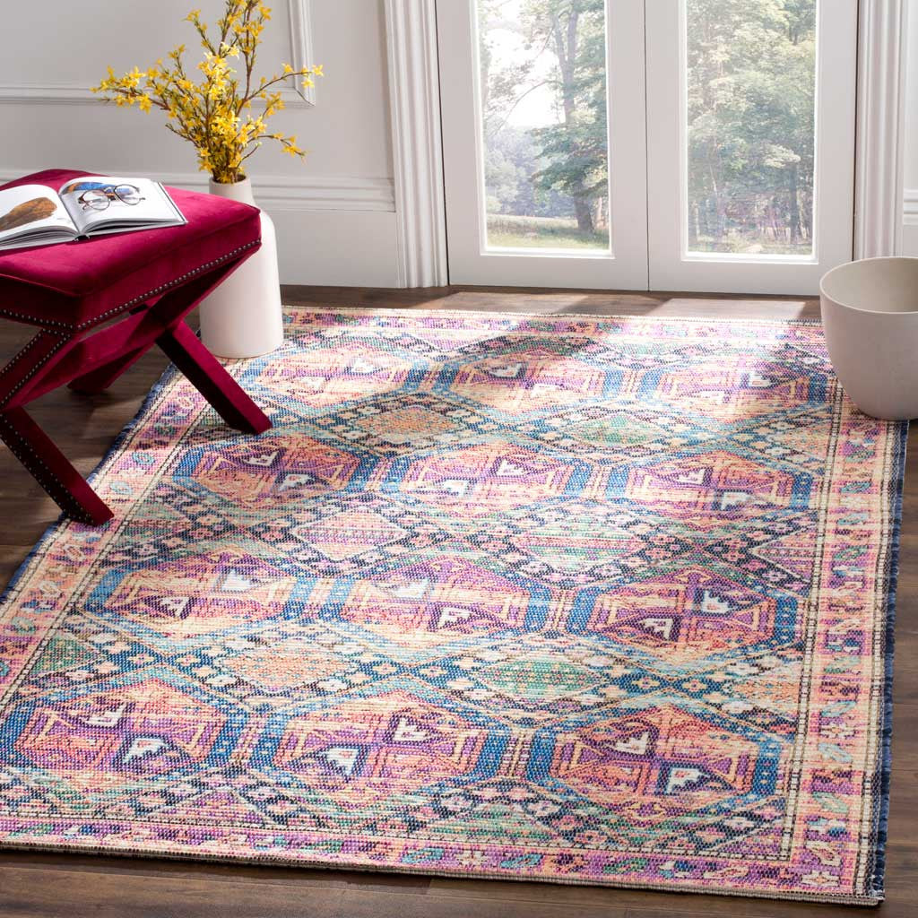 A vibrant geometric rug brightens wood floors with pink, purple, and blue medallions