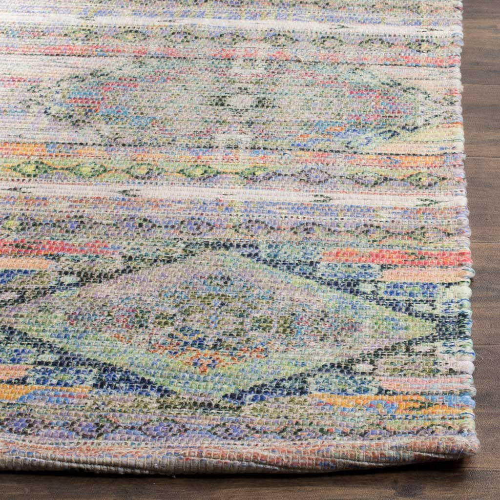 Multicolored yarns trace a diamond motif along the rug's neatly finished edge