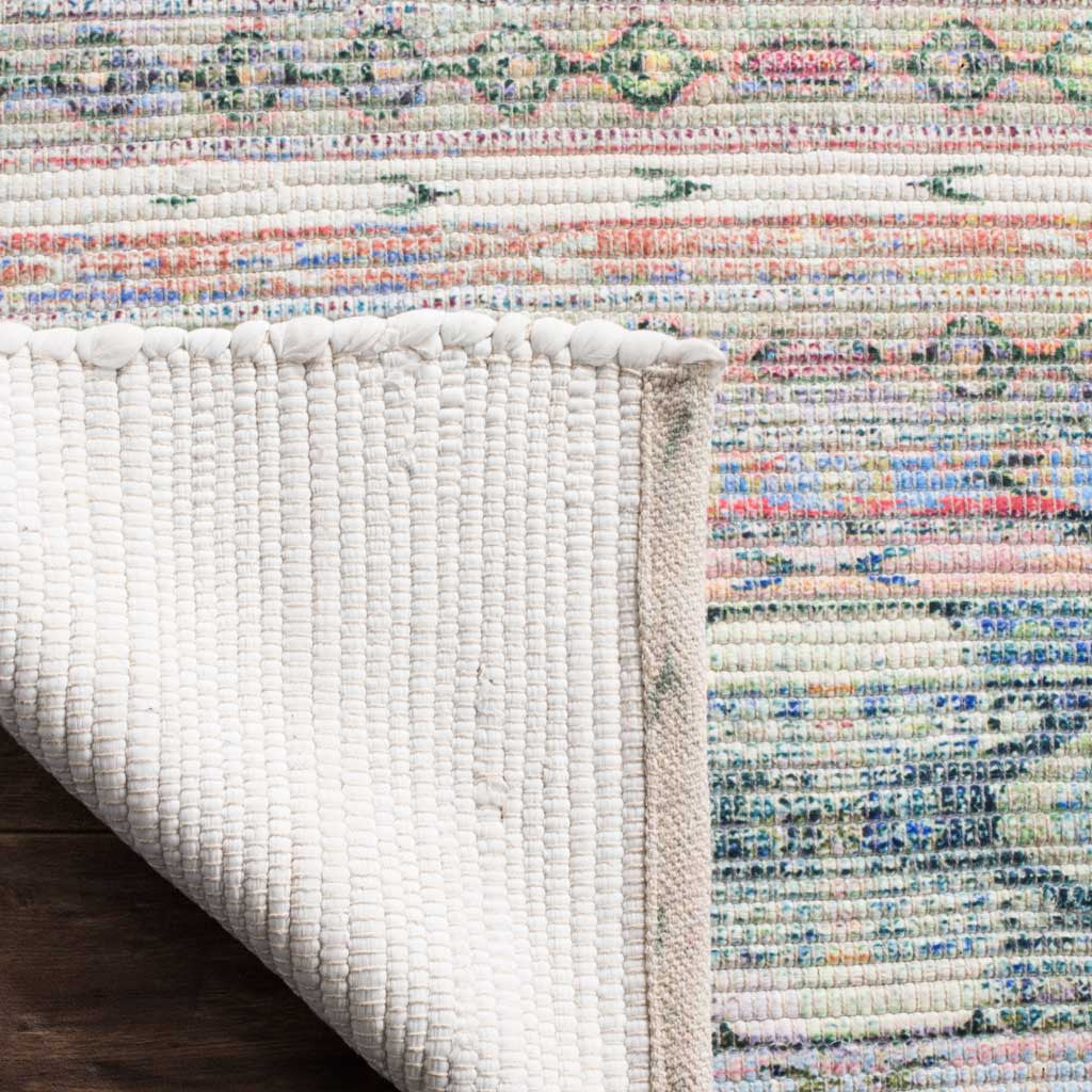 An ivory woven backing and bound edge complement the rug's colorful patterned surface
