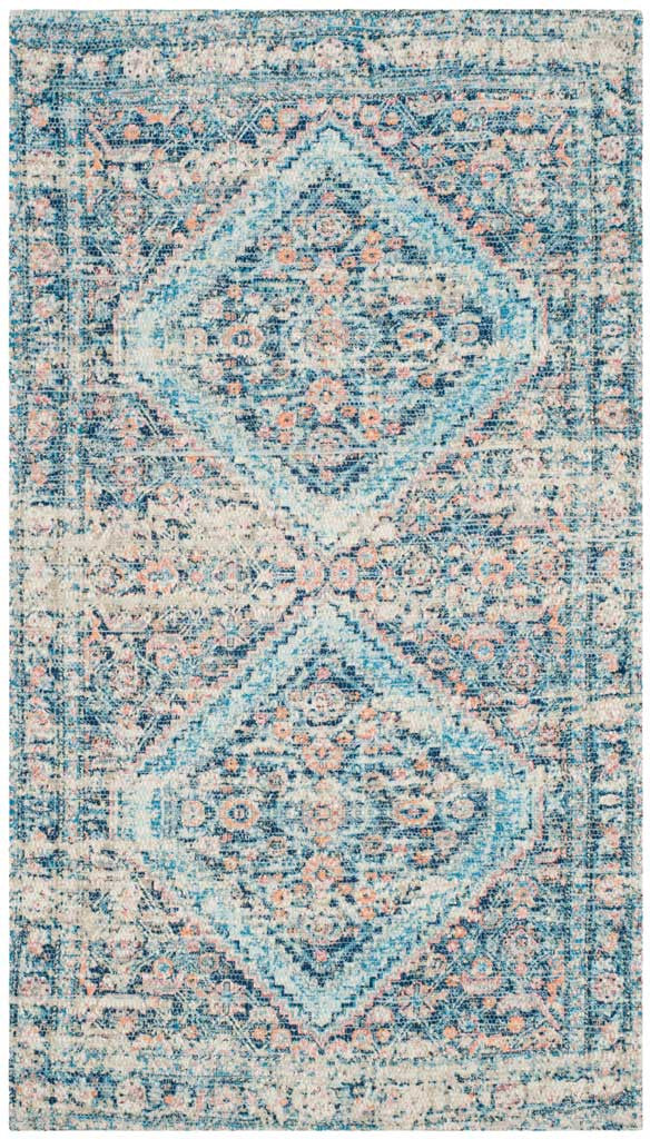 Layered diamond motifs and coral accents give the blue rug a relaxed, vintage-inspired look