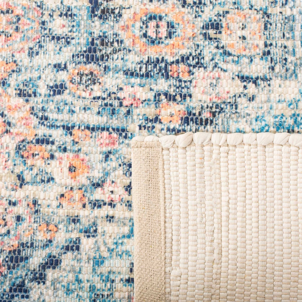 Cream woven backing complements a textured rug with blue, turquoise, and coral patterning