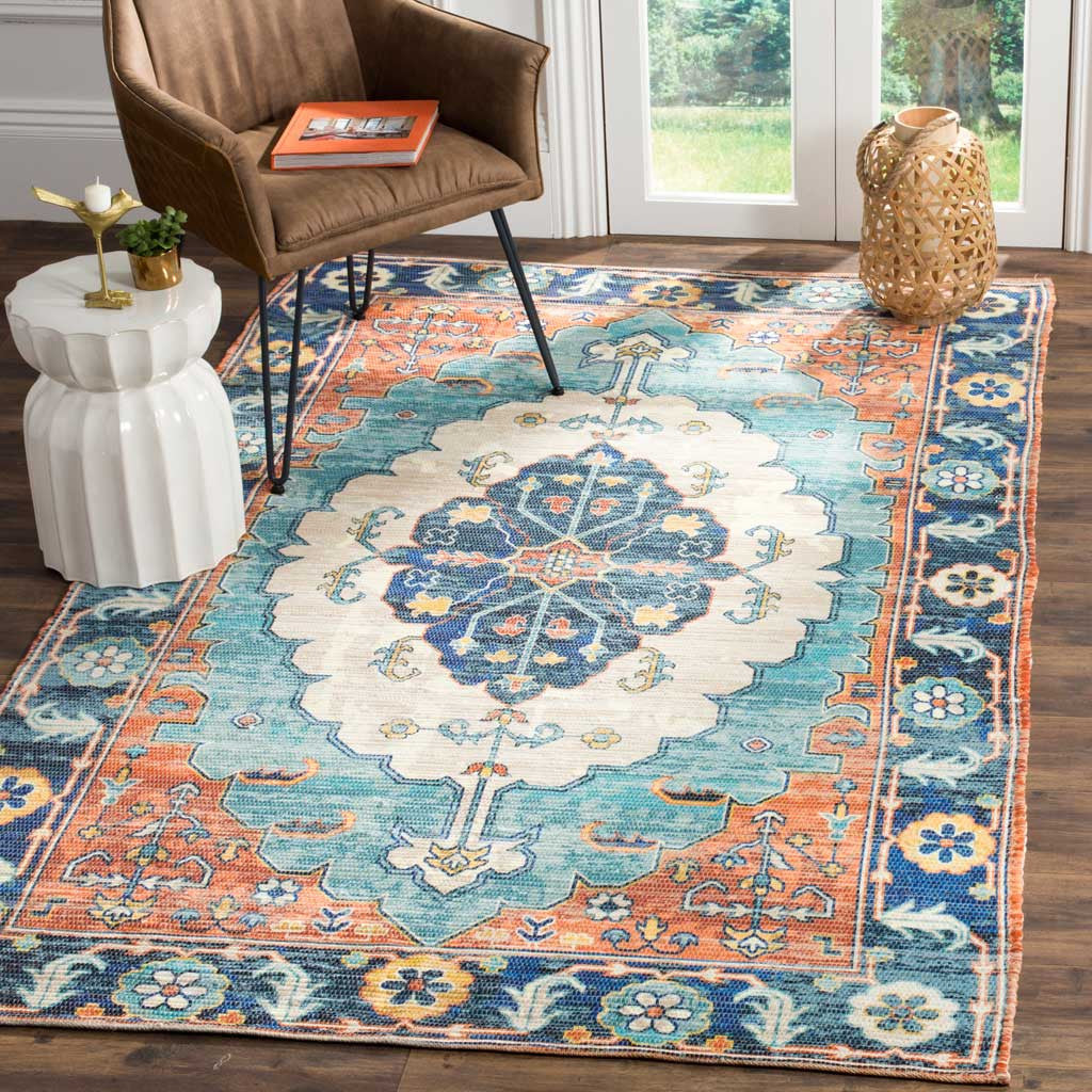 An intricate medallion rug in blue, coral, and ivory brings traditional charm to a living area.