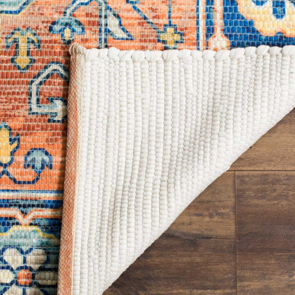 Textured ivory backing complements the rug's colorful coral and blue pattern.